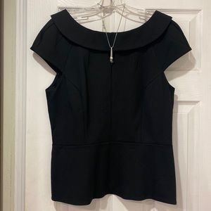 Cap sleeve peplum top. Necklace sold separately.